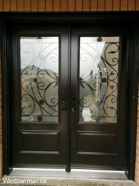 Double front steel insulated entry exterior doors. Black spray booth paint. Three quarters glass. Traditional design. Campbell ford traditional wrought iron glass door inserts